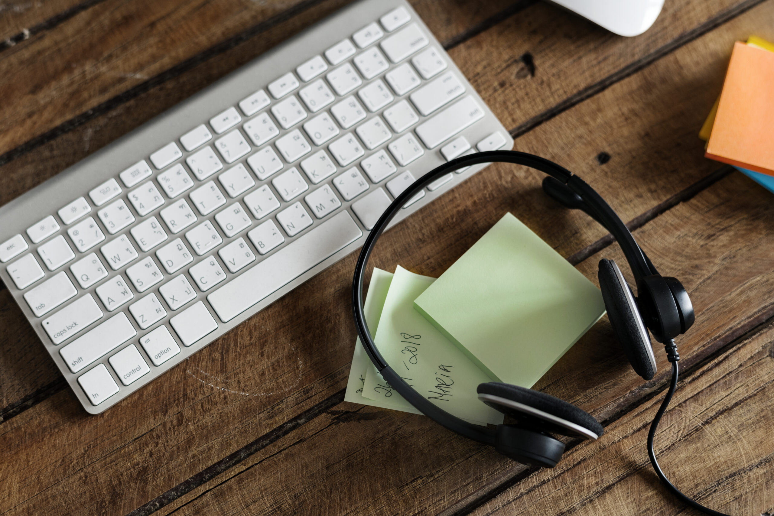 aerial view headphones keyboard wooden table scaled